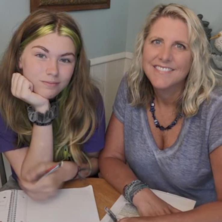 女士的照片. Kinney and her daughter smiling after studying for an online class together